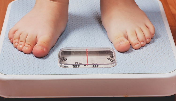kid on scales - راه و روش هایی موثر برای کنترل و درمان چاقی کودکان